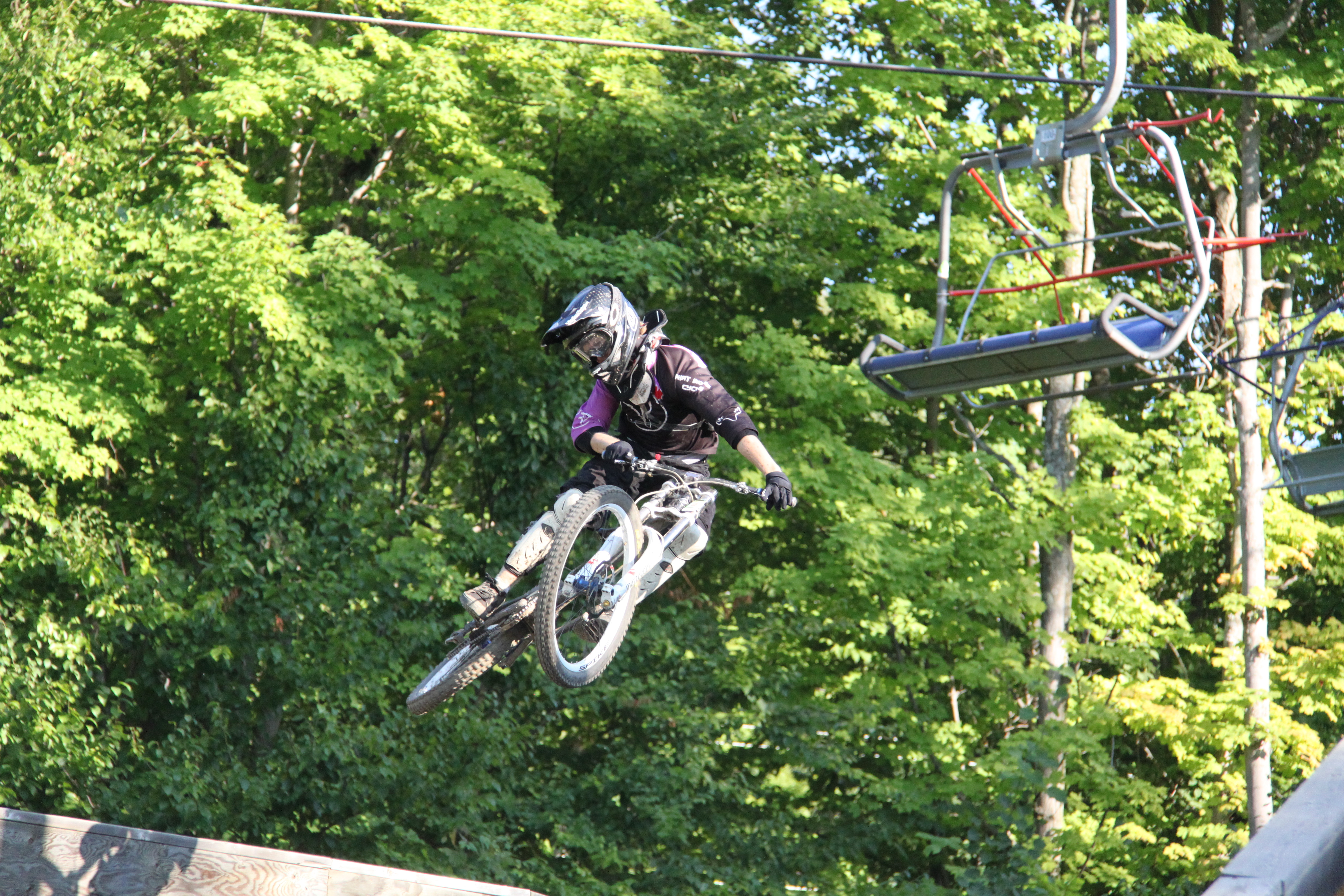 Downhill rider getting some air at Ski Bromont, Bromont, Quebec.